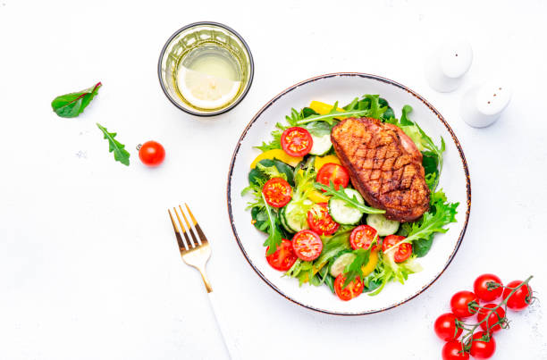 istock Salad with duck breast, lettuce and vegetables, white background, top view 2188503841