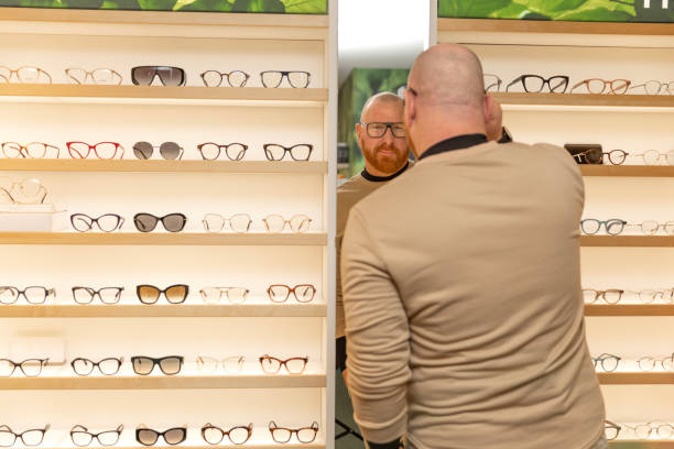 istock A handsome redhead man choosing new eyeglasses in the shop 2188505252