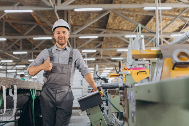 istock Factory male bearded worker show thumbs up is programming a CNC milling machine with copy space. 2188506163