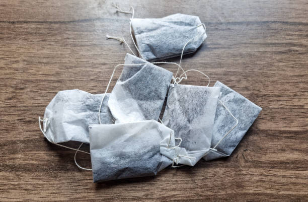 Tea-bags on wooden background