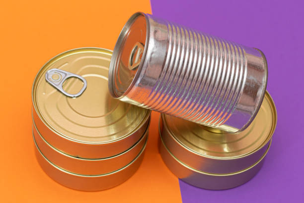 istock A Group of Stacked Tin Cans with Blank Edges on Split Orange and Violet Background 2188508155