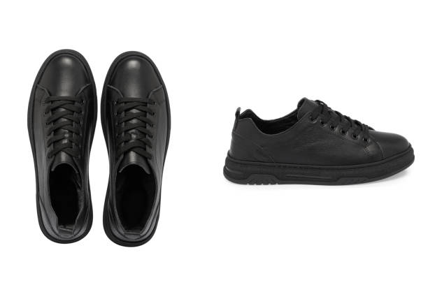 children's sneakers in black with a white stripe on the sole on a white background. light and comfortable shoes for sports and outdoor walks. stylish and fashionable shoes