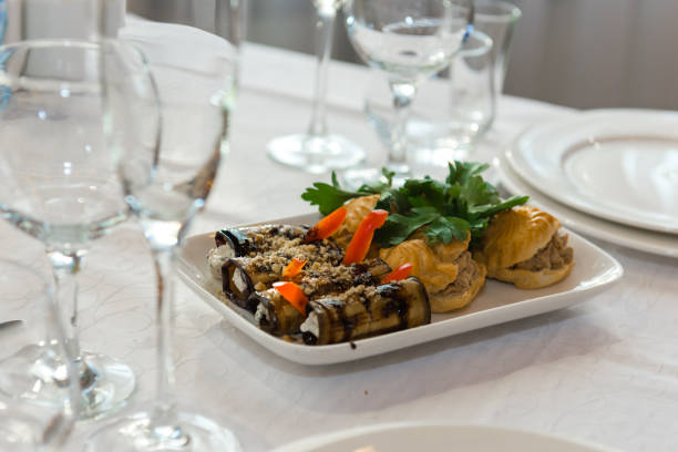 The dish from fine dining is meticulously presented on a white plate in a luxury restaurant, embodying both elegance and a delectable culinary experience.