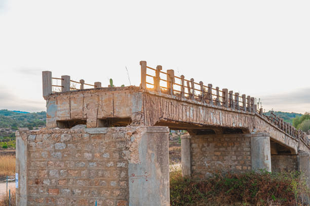 istock Landscape with an Abandoned Bridge at Sunset with Crumbling Stone and Concrete Structure, Showing the Beauty of Decay and Nature's reclaiming of Manmade Constructions in a Historic Countryside Setting 2188509611