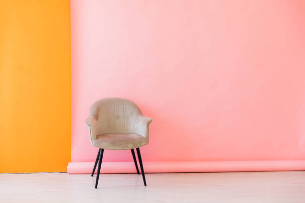 istock Beige chair by pink orange wall and white floor 2188510431