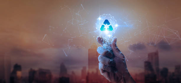 istock Recycling Concept with Hand Holding Digital Light Bulb Over Cityscape 2188512177