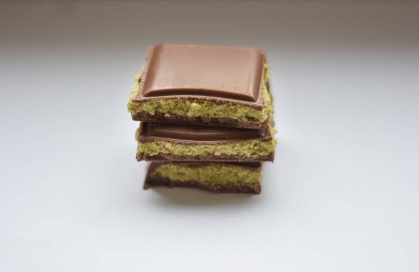istock Dubai Chocolate bar with green kadayif and peanut butter on white background 2188512243
