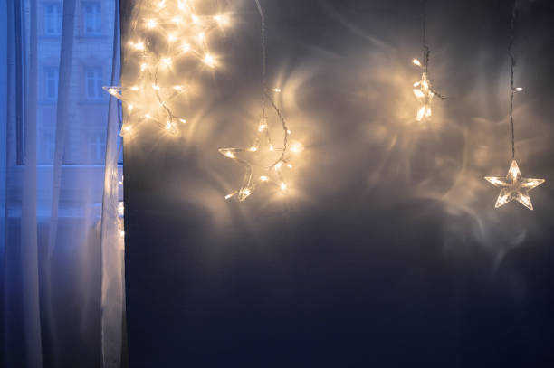 istock dark background of christmas lights on wall 2188512344