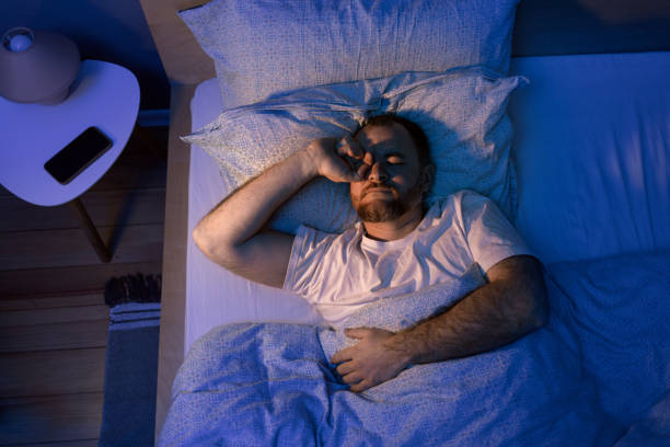 istock Man Stretching In Bed After Waking Up In The Morning 2188512395
