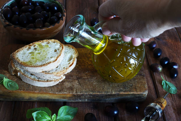 istock Pouring olive oil over slices of bread. 2188512640