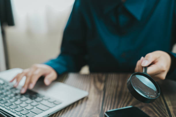 istock person examining data with magnifying glass while using laptop. focus is on analysis and attention to detail in modern workspace 2188513320