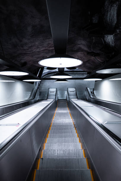 This image captures a futuristic underground escalator in a modern subway station, featuring innovative lighting and sleek architecture. It highlights urban transportation and commuter efficiency.