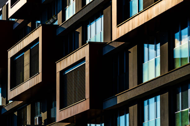 Modern Architectural Facade with Geometric Protrusions and Reflective Windows in Sunlight