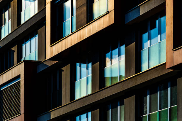 istock Modern Architectural Facade with Geometric Protrusions and Reflective Windows in Sunlight 2188513585