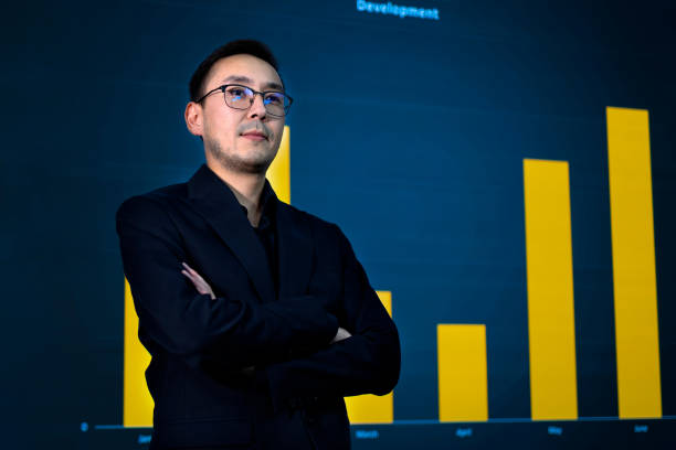 istock Smiling entrepreneur in eyeglasses with crossed arms presenting growth analysis 2188514993