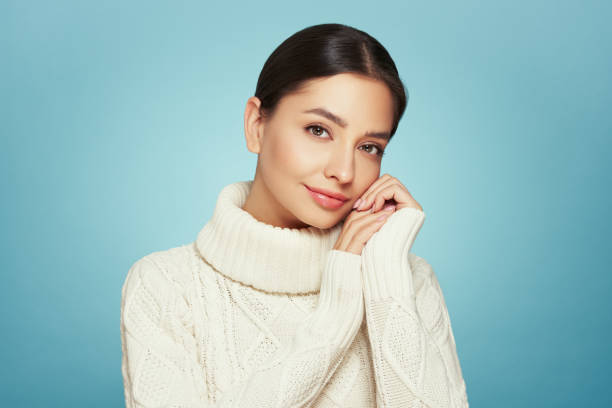 istock Young beautiful woman in a warm  white sweater 2188515045