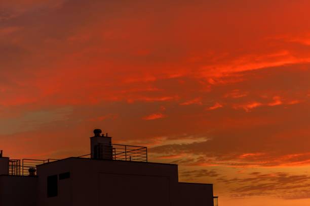 The dramatic sunset sky with vibrant red and orange clouds in Lima, Peru