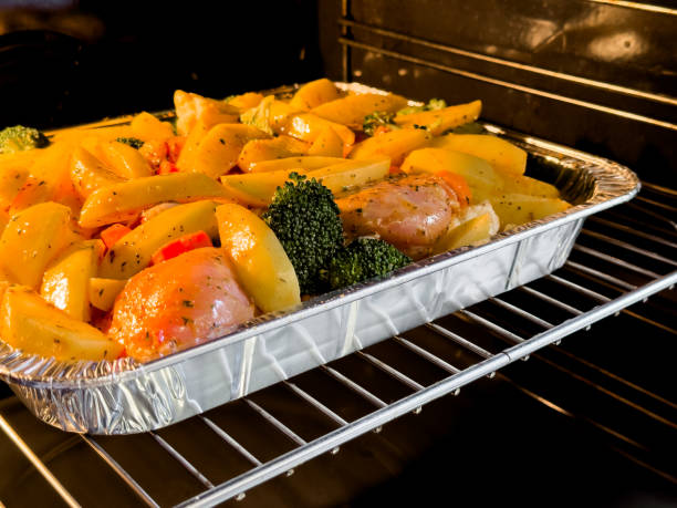 istock Baked chicken and vegetables in oven with potatoes and broccoli 2188516295