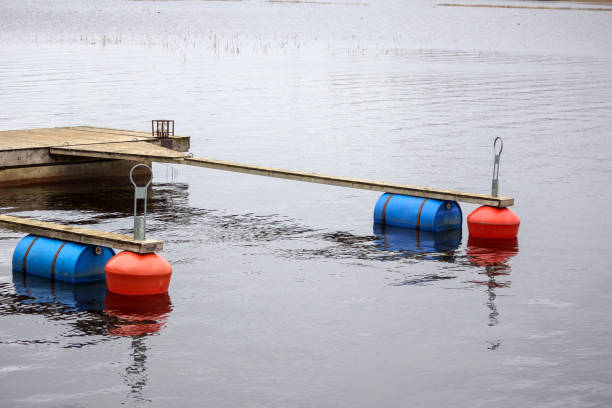 istock .A boat dock with a boardwalk and buoys on the water 2188517042