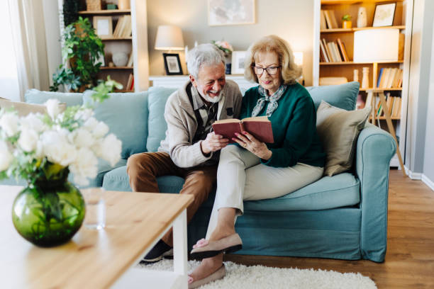 istock Senior couple reading book at home 2188517082
