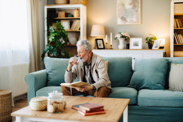istock Senior man reading book and resting at home 2188517352