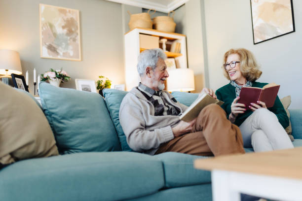 istock Senior couple reading book at home 2188517437