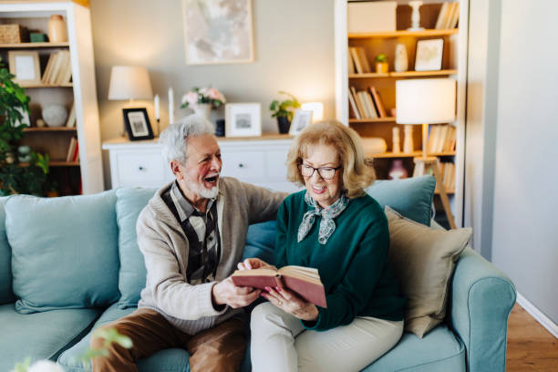 istock Senior couple reading book at home 2188517570