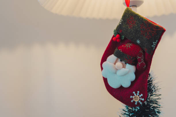 A s stocking with Santa design hanging on lamp, festive decor