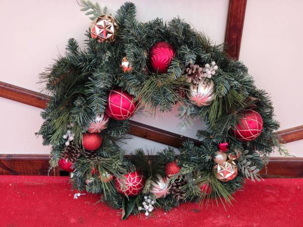 istock Christmas wreath standing next to a white surface 2188520239