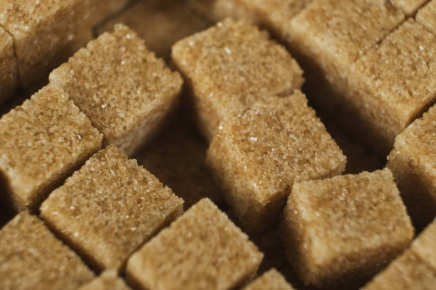 istock Macro cubes of brown cane unrefined demerara sugar. 2188520613