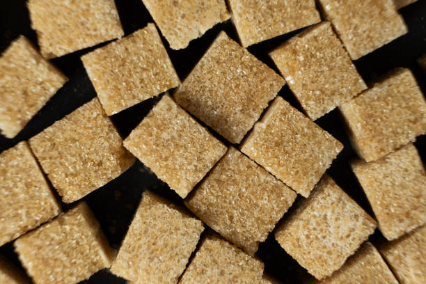 istock Cubes of brown cane unrefined demerara sugar. 2188520626