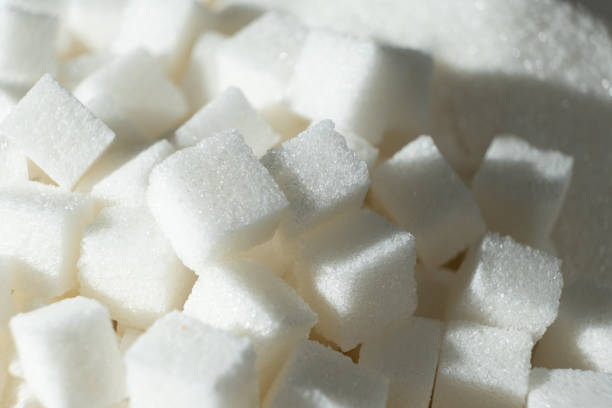 White sugar cubes on black background