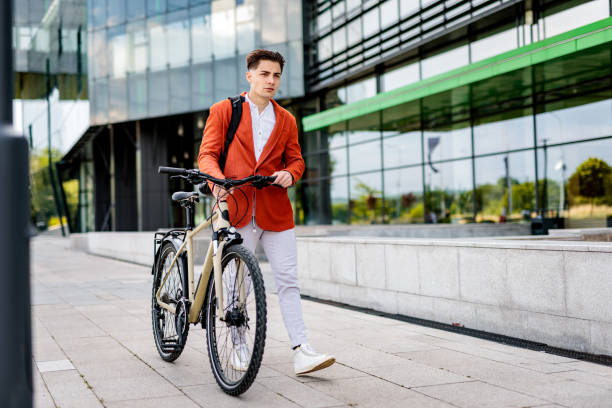 istock Young businessman walking with bicycle after work 2188520901