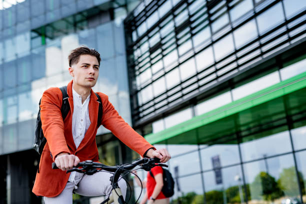 istock Young businessman rides bicycle 2188521004
