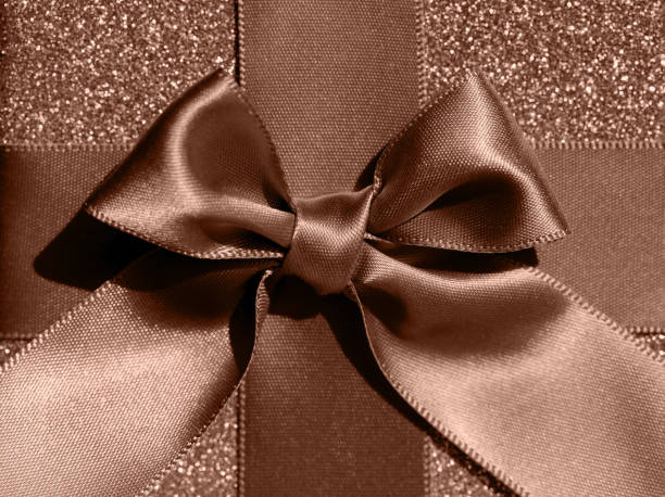 Red Ribbon on golded paper background.