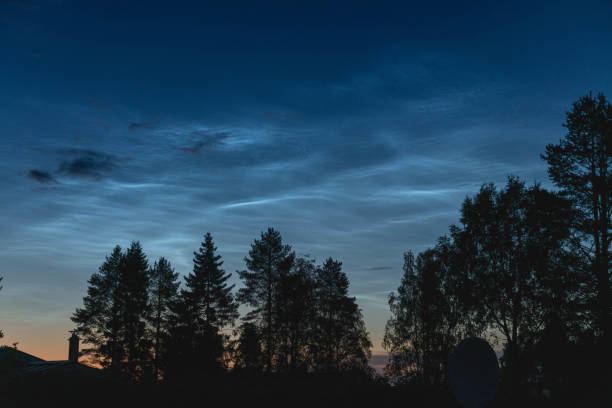 istock Noctilucent clouds illuminating the night sky above a forest 2188525691
