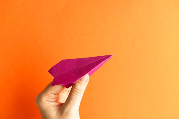 istock Hand Holding a Pink Paper Plane 2188526993