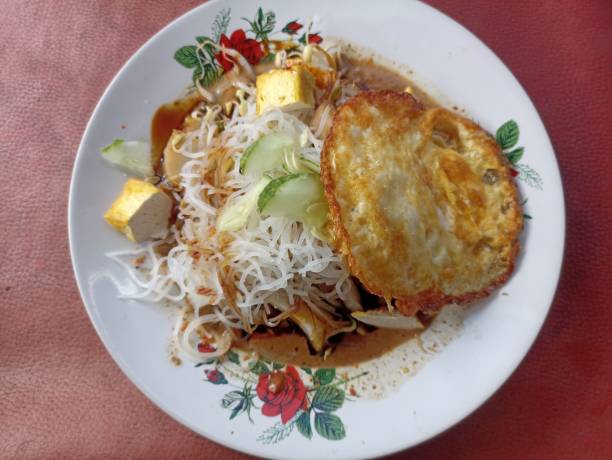 istock Ketoprak, gado-gado with vegetable topping, fried egg and peanut sauce. Typical Indonesian street food 2188530223