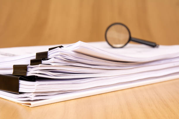 istock Organized Documents with a Magnifying Glass for Thorough Inspection and Review Processes 2188531163