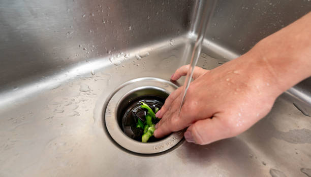 istock Efficient food waste disposal using a kitchen sink garbage disposer under running water 2188532630