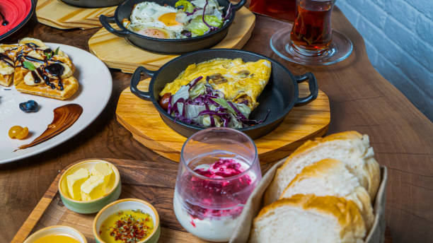 istock Delicious brunch spread with various dishes and beverages at a cozy cafe 2188532819