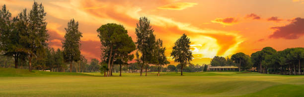 istock A golf course glowing under a dramatic sunset sky, surrounded by lush trees and vibrant colors, offering a breathtaking view. 2188532863