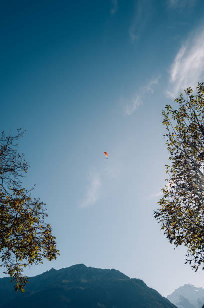 young man paragliding in clear cloudy weather