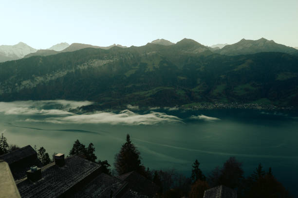 Scenic view of fog rolling over lake lucerne with mountain view in switzerland