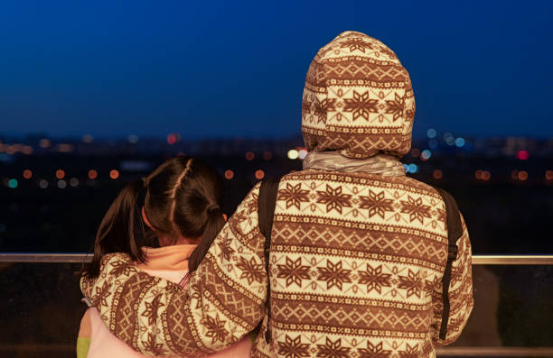 Mother and daughter looking at view