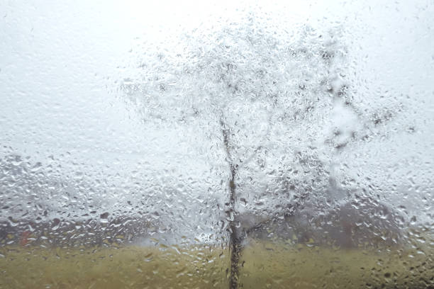 Water drops on glass window with autmn british scenery
