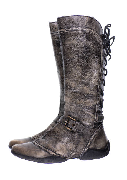 Pair of beige leather boots with laces, featuring a sturdy sole and detailed stitching. Isolated on a white background, ideal for fashion, outdoor gear, or product advertising.