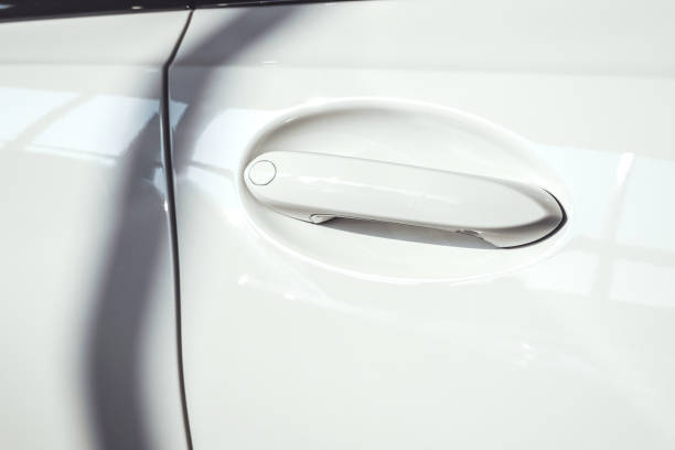 Close up of a white car, detail, focus on a a handle