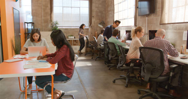 istock Designers In Creative Business Working At Desks In Modern Open Plan Multi-Cultural Office 2188540267