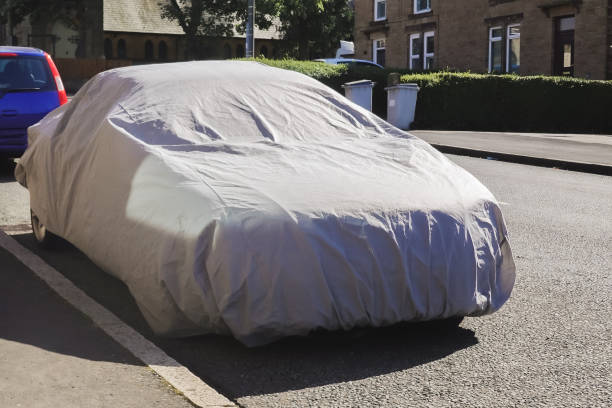 istock covered car on the sideway in the street 2188541774